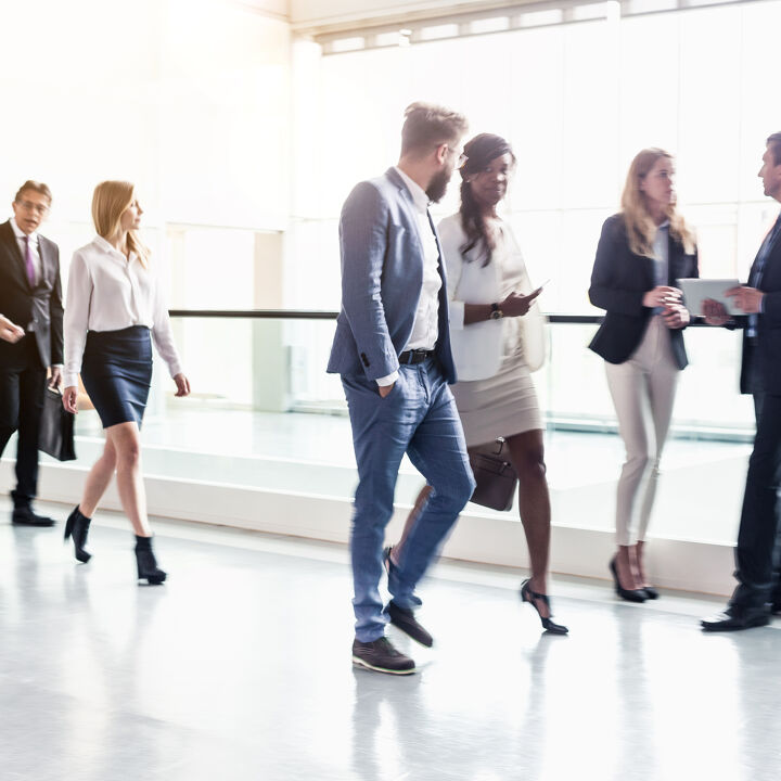 Business-coworker-walking-along-office-coridor