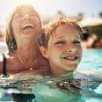 grand-mere se baignant avec son petit fils dans la piscine